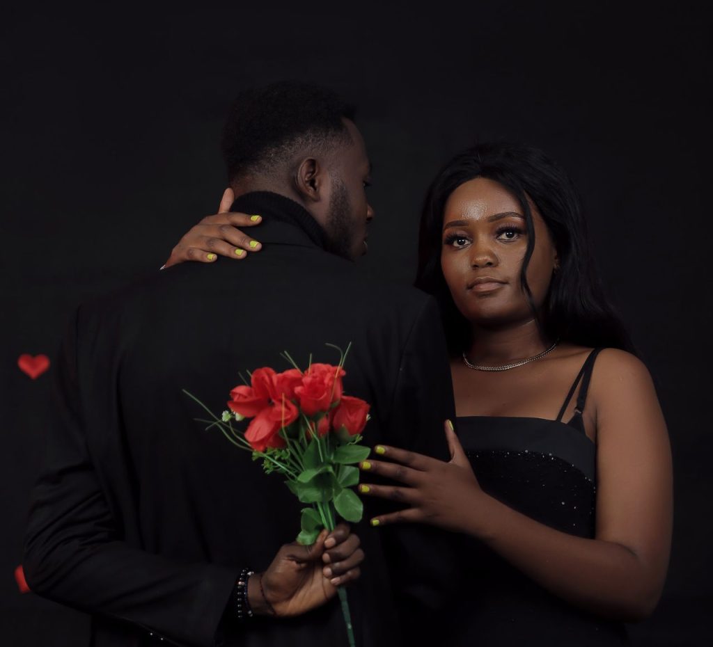 pexels-photo-16955100-16955100 Elegant couple in evening attire with roses, capturing romance in a studio setting.