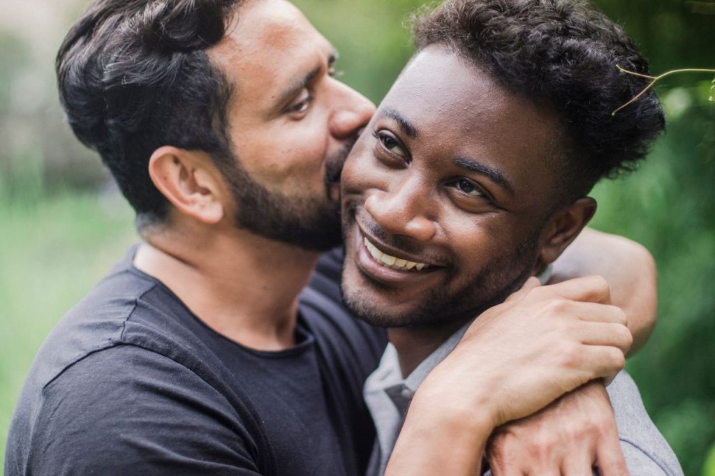 Intimate portrait of a joyful couple embracing outdoors, showcasing love and happiness.