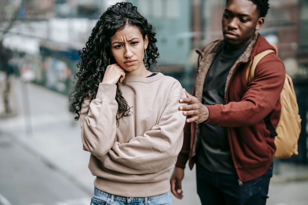 pexels-photo-6147279-6147279 Sad young multiethnic couple in casual clothes standing in city street while having disagreement in daylight